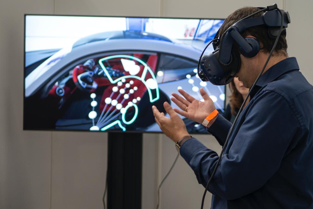 User experiencing virtual reality using a VR headset and screen
