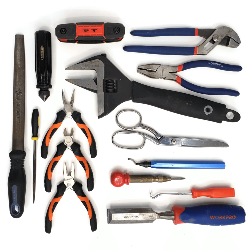 Various hand tools including wrench, pliers, files, and scissors